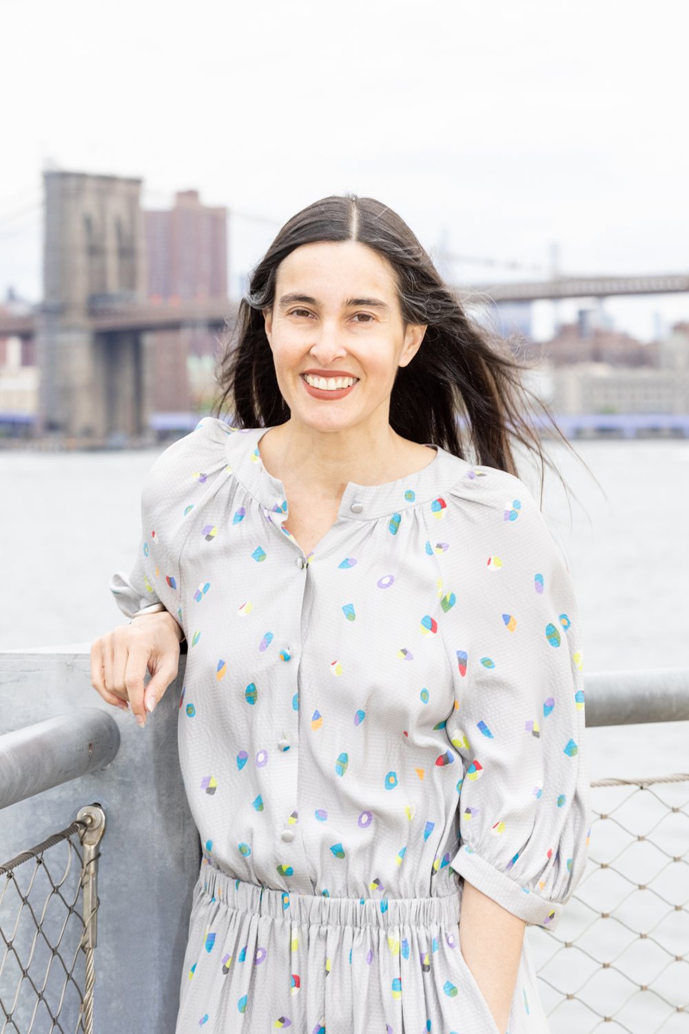 Donna Freitas in Brooklyn with the Brooklyn Bridge behind her