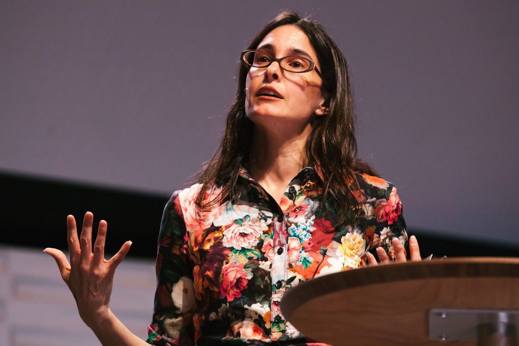Donna Freitas speaking at a lectern